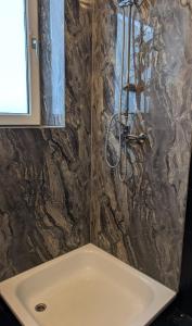 a bathroom with a sink and a shower at Stadtnah an der Förde 7502 E in Flensburg +21 photos