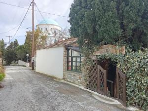 a small building with a water tower in the background at Mary Mary! in Agios Kirykos