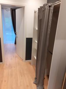 a room with white walls and a door with curtains at 100pro-Apartments in Detmold