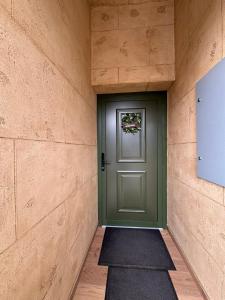 a green door in a brick wall with a rug at Just a Dream - guest apartments in Troyan
