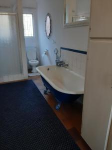 a bathroom with a tub and a toilet and a sink at Portia inn accommodation in Pretoria