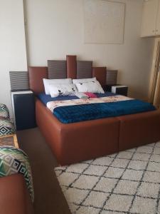 a bedroom with a large bed with a blue comforter at Portia inn accommodation in Pretoria