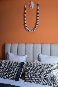 a mirror on the wall above a bed with pillows at Accès direct piscine - appartement avec jardin in Marrakesh +4 photos