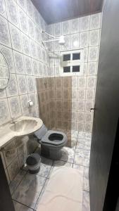 a bathroom with a toilet and a sink at Nalu Suítes Maresias in Maresias +14 photos