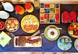a table topped with plates of food and snacks at B&B Chalet Il Picchio in Varzo