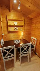 a wooden room with a table and two chairs at Holzhaus direkt am See in Priepert
