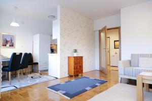 a living room with a table and a dining room at Guest Apartment Visoko in Visoko