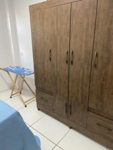 a wooden cabinet in a room with a table at AP Evangelista in Caruaru