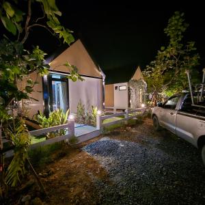 a car parked in front of a house at night at ลึกลับรีสอร์ทบ้านนา in Nakhon Nayok +3 photos
