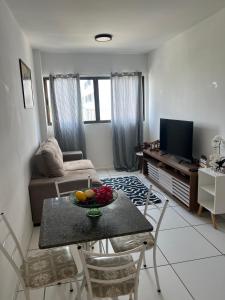a living room with a table with fruit on it at AP Evangelista in Caruaru