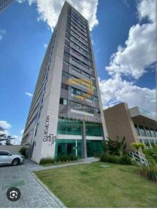 a tall building with a car parked in front of it at AP Evangelista in Caruaru