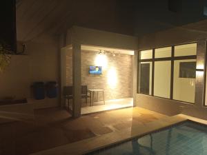 a room with a swimming pool in a house at AP Evangelista in Caruaru