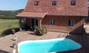 a house with a swimming pool on a wooden deck at Les jumelles in Sarlat-la-Canéda