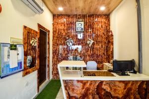 a room with a stone wall with a counter at Hotel O Kanchan Residency in Kota