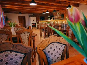 a dining room with chairs and a table with a flower at Althanský penzion in Znojmo