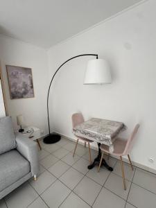 a living room with a table and a couch at Mon Appart avec Terrasse et Piscine in Roquebrune-Cap-Martin