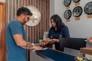a man and a woman standing at a reception desk at Hotel Santa Fe in Puerto Ayora +90 photos