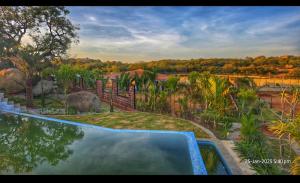 an overhead view of a swimming pool in a backyard at Unwind Farm Retreat in Hyderabad