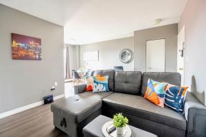 a living room with a couch and a table at Charming Newly Renovated Condo - Glenview West in Hamilton