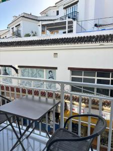 a table and chairs on the balcony of a building at Marco Apartment By Torremolinos On-line in Torremolinos