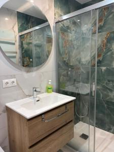 a bathroom with a sink and a shower at Marco Apartment By Torremolinos On-line in Torremolinos +7 photos