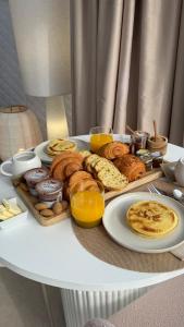 a tray of breakfast foods on a table at Les Dômes du Moulin in Urtaca +13 photos