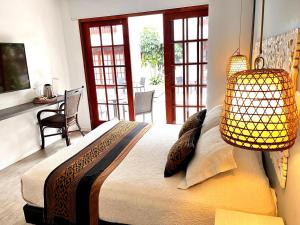 a bedroom with a large bed with a lamp at Lombok Hotel & SPA antes Hotel Casablanca in Guaduas