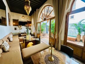 a living room with a couch and a table at Riad Jardin Des Sens & Spa in Marrakesh