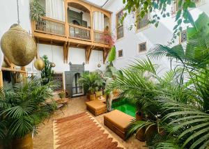 an indoor courtyard with plants and a swimming pool at Riad Jardin Des Sens & Spa in Marrakesh