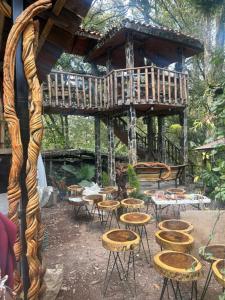 a wooden gazebo with chairs and tables at Casa Machtiani in Cedro +10 photos