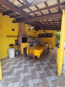 a patio with a table and chairs and a kitchen at Pousada da Tom-Ubatuba Perequê-Açu in Ubatuba +25 photos