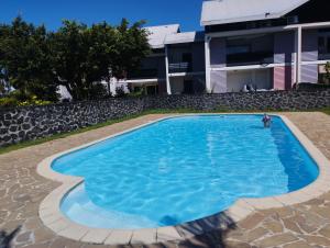 a swimming pool in front of a building at Dauphin bleu in Saint-André