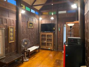 a living room with a tv and a fan at Sea Pines & Liberg in Nai Yang Beach