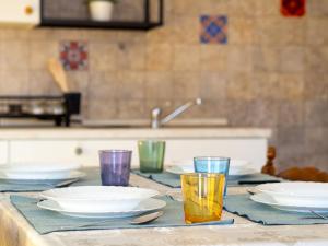 a table with plates and bowls and glasses on it at Large apartment with terrace AC e WiFi in Sesto San Giovanni +13 photos