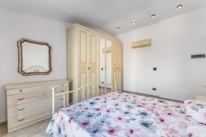 a bedroom with a bed and a dresser and a mirror at Large apartment with terrace AC e WiFi in Sesto San Giovanni