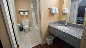 a bathroom with a sink and a toilet at Apollo Lodge and RV Park in Fairfield +34 photos