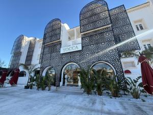a store front of a building with a sign on it at Yocca Hotel Residence in Hammamet