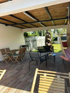 a patio with a hammock and a table and chairs at Villa Valérie in Bras-Panon