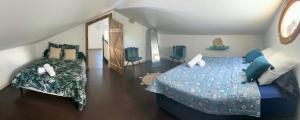 a bedroom with a large bed and a couch at Villa Valérie in Bras-Panon