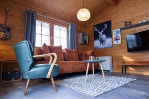 a living room with a couch and a blue chair at Küstenhaus Silbermöwe in Cuxhaven