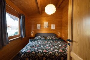 a bedroom with a bed in a wooden room at Küstenhaus Silbermöwe in Cuxhaven