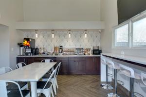 a kitchen with wooden cabinets and a table and chairs at Hotel Seville - Ontario Airport/Chino in Ontario