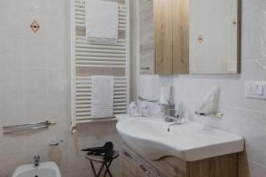 a white bathroom with a sink and a toilet at Casa Dama in Casaleone +18 photos