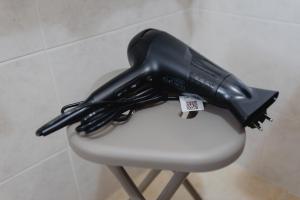 a black appliance sitting on top of a white chair at Casa Dama in Casaleone