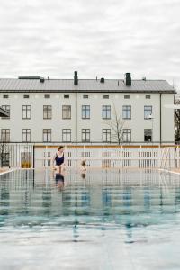 a woman and a child sitting on the edge of a swimming pool at SpaHotel Hamina in Hamina