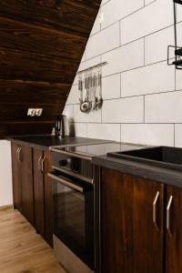 a kitchen with a stove and a counter top at Pokoje u Jozka-Widok na Tatry in Groń