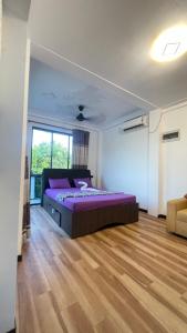 a bedroom with a bed and a large window at Ayathma Heights in Weligama