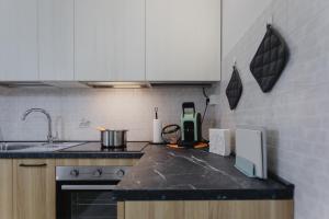 a kitchen with white cabinets and a counter top at Casa Dama in Casaleone