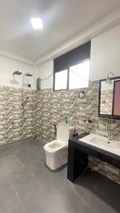 a bathroom with a toilet and a sink at Ayathma Heights in Weligama +38 photos