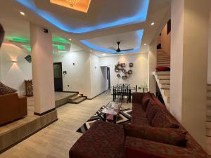 a living room with a couch and a blue ceiling at Ayathma Heights in Weligama